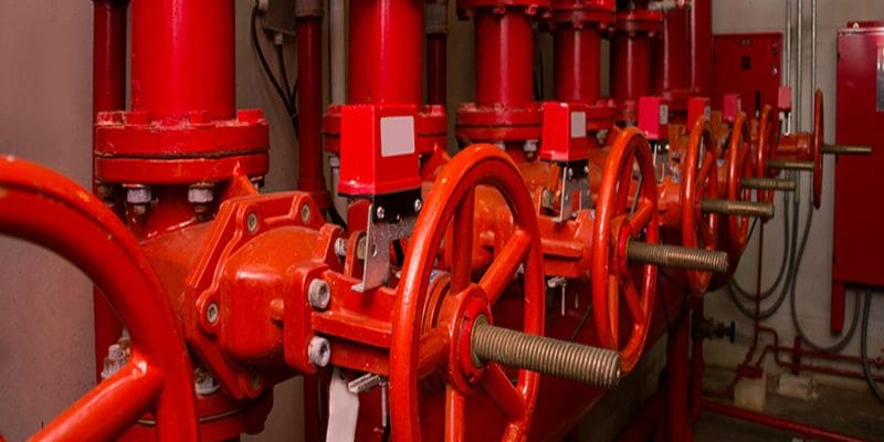 A group of red valves sitting next to each other.