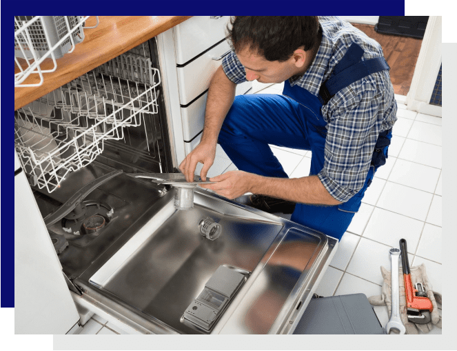 A man working on the dishwasher in a kitchen.